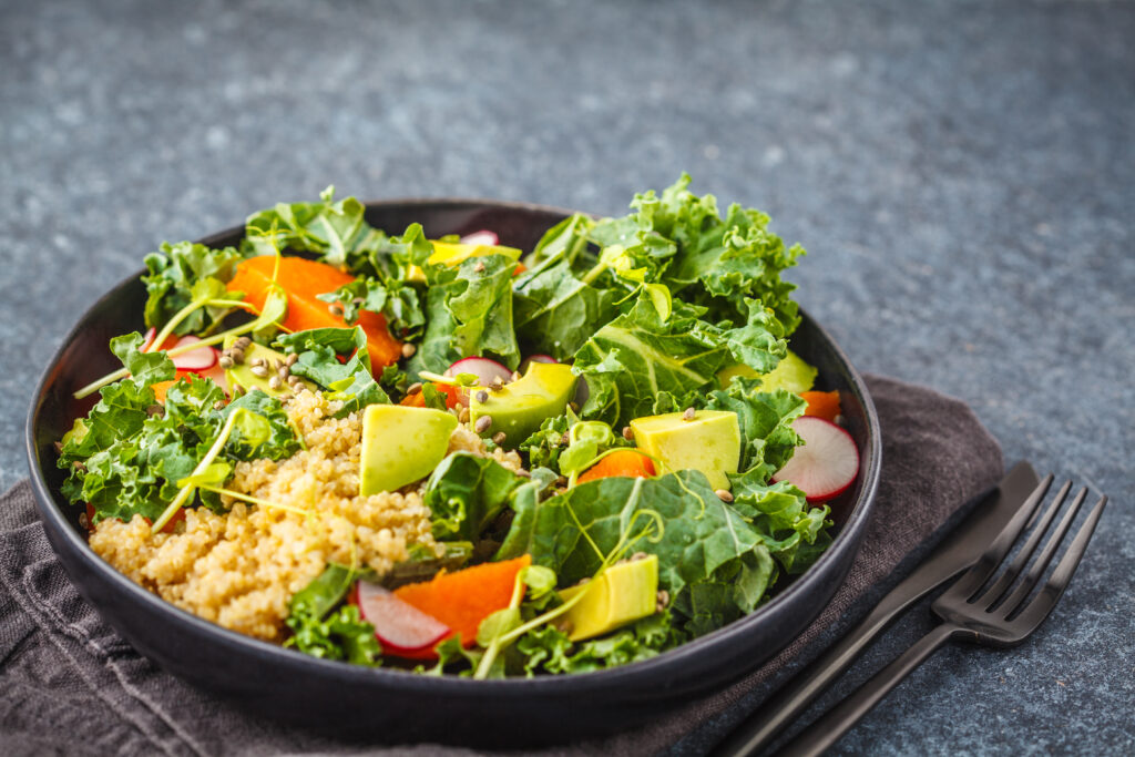 Kale, Quinoa and Avocado Salad in a dish on a grey table
