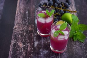 two mocktails on a wooden plank