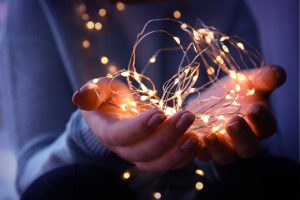 hands holding sparkly lights