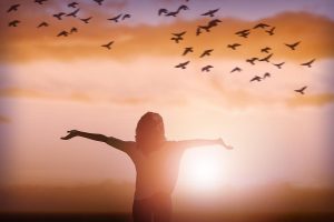 Joyful life - woman in front of sunset