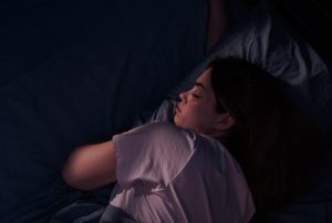 woman sleeping in a dark bedroom