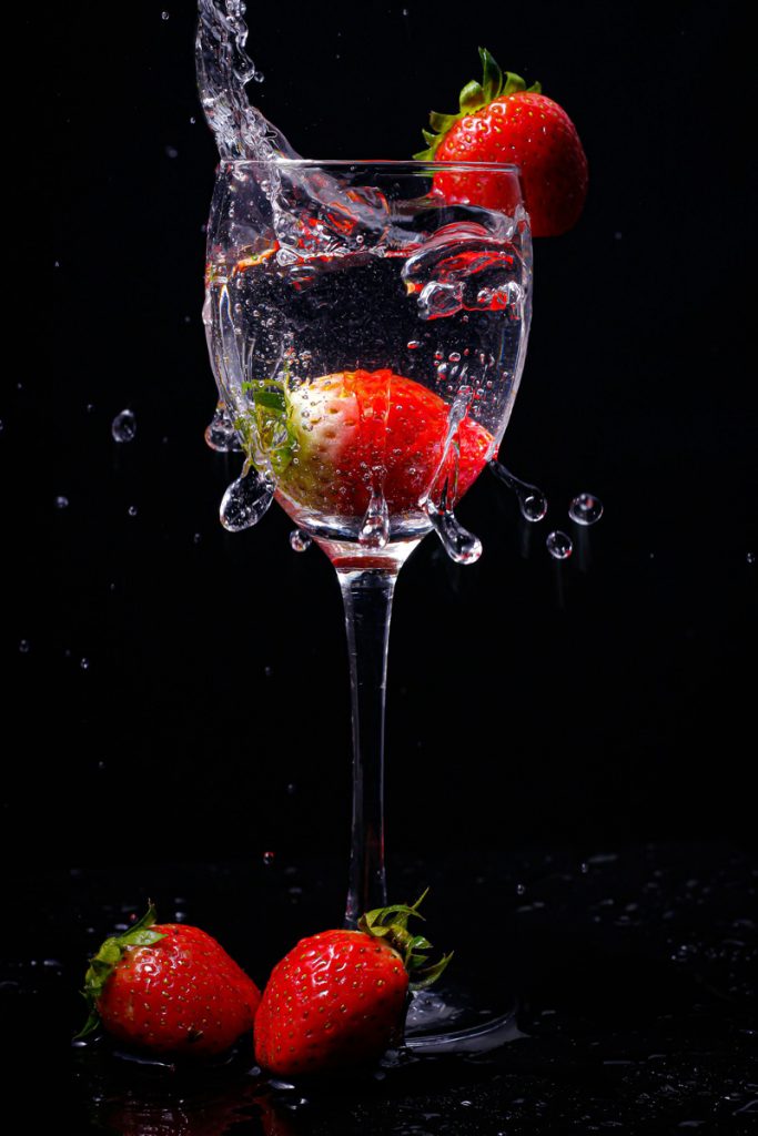 strawberries and water in a long stem glass