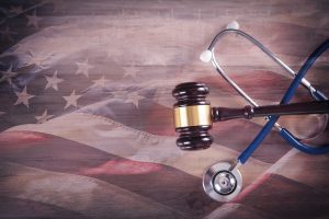 stethoscope and gavel laying on American flag