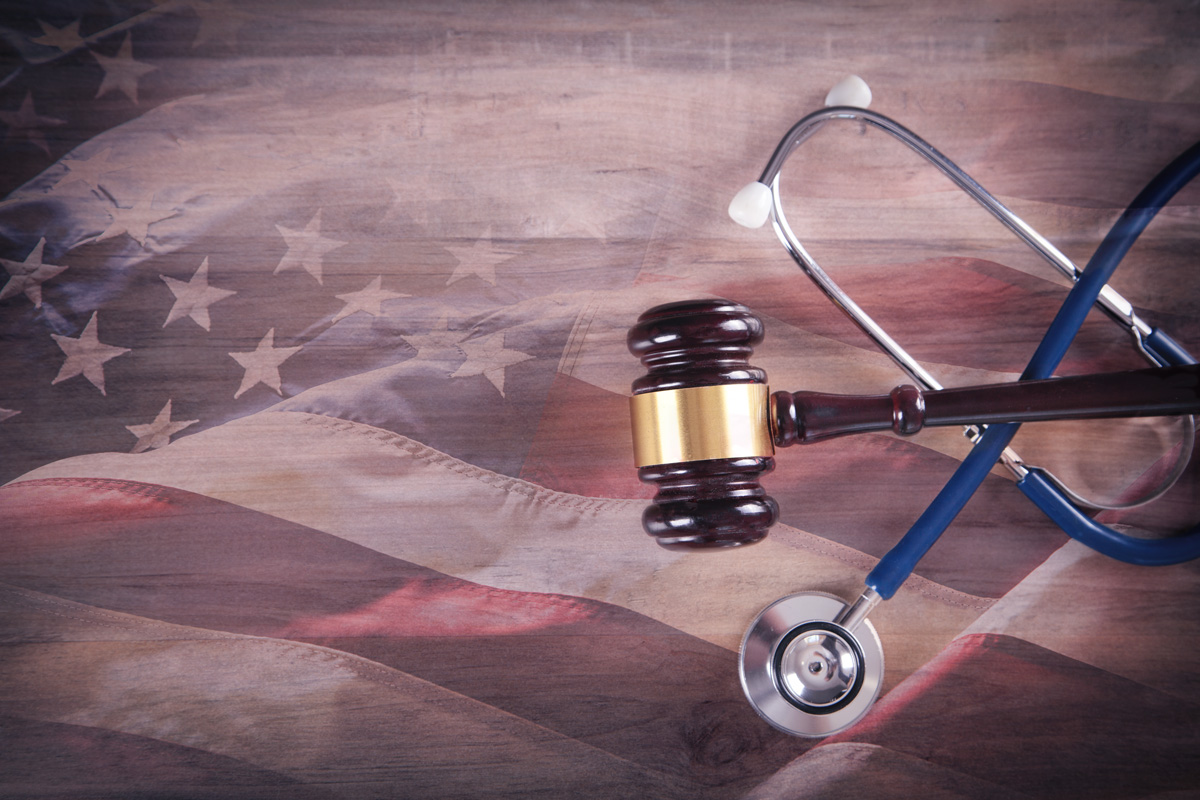 stethoscope and gavel laying on American flag