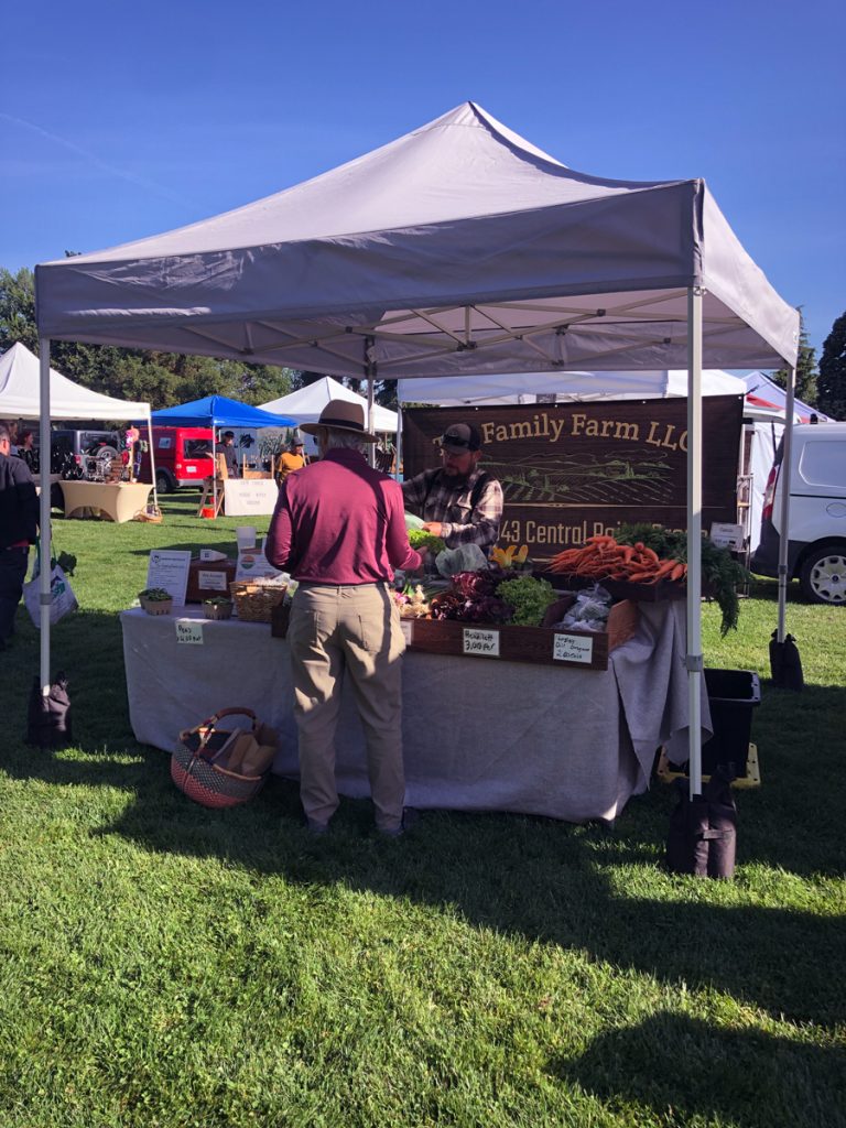 Family Farm LLC farm stand on green grass