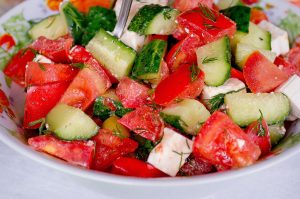 Melon, Cucumber, Feta Salad in a white bowl
