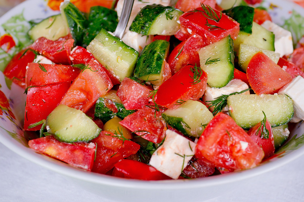 Melon, Cucumber, Feta Salad in a white bowl